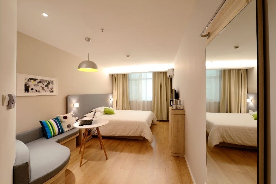 Light beige walls add warmth to this cozy, modern bedroom.