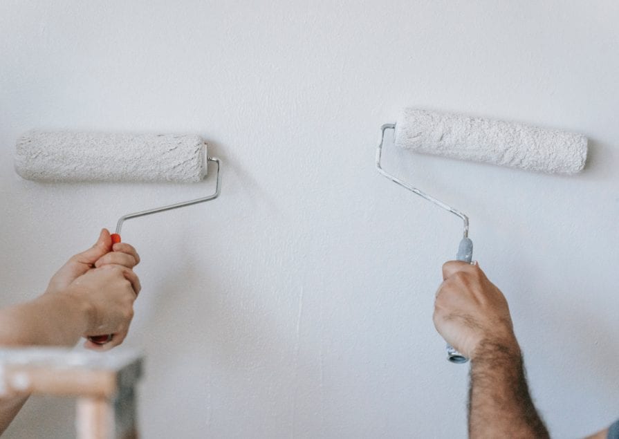 Two People Using a Paint Roller